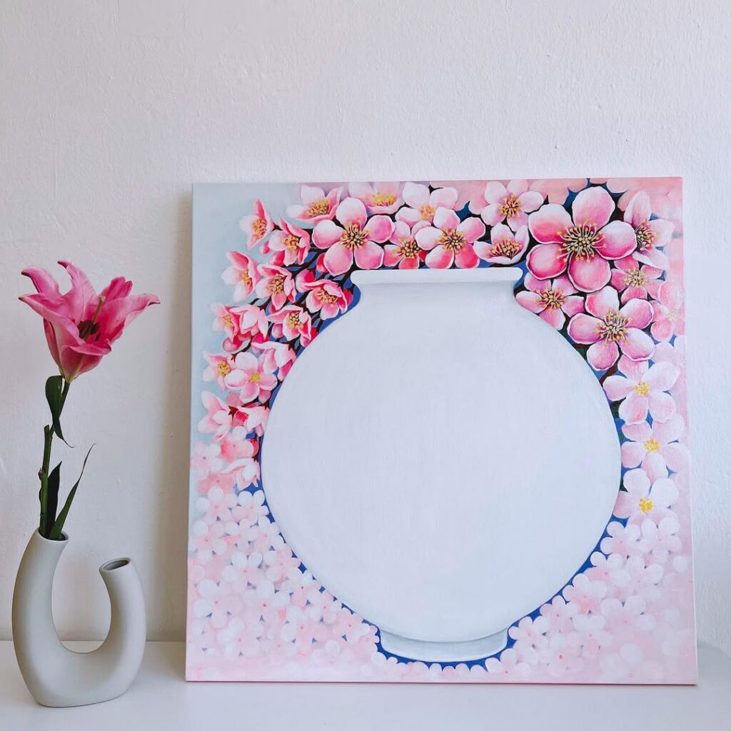 Moon jar oil painting surrounded by cherry blossoms.